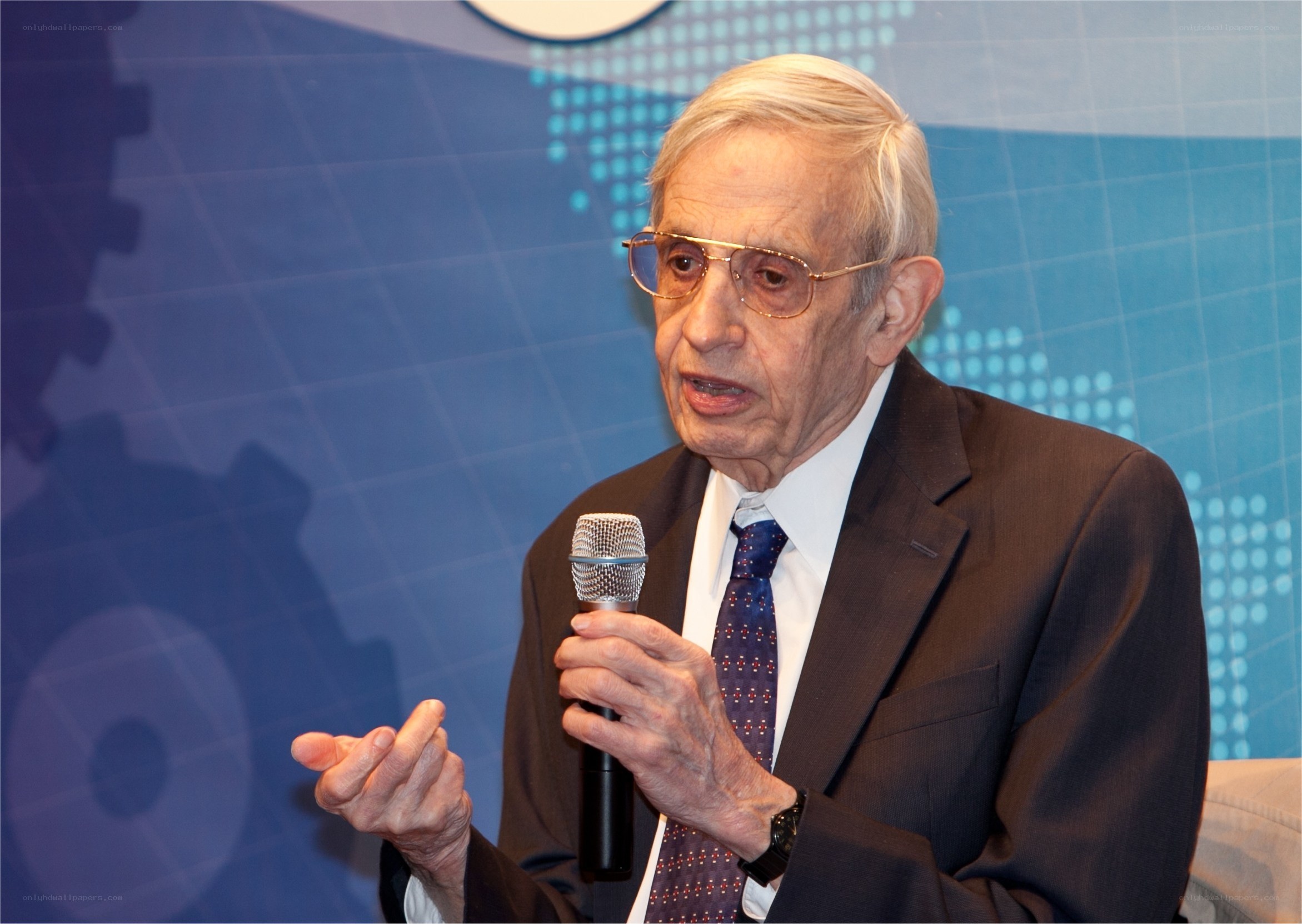 elderly man speaking into microphone