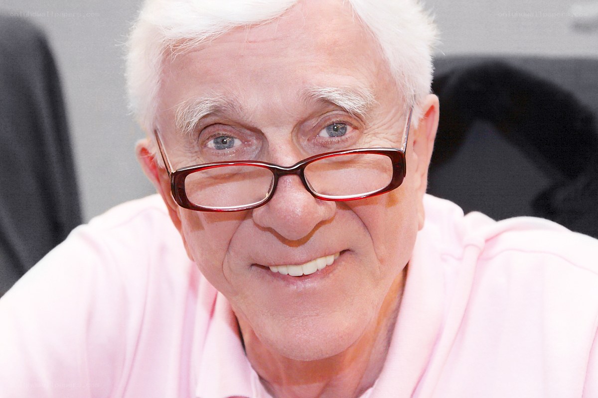 elderly man with glasses smiling