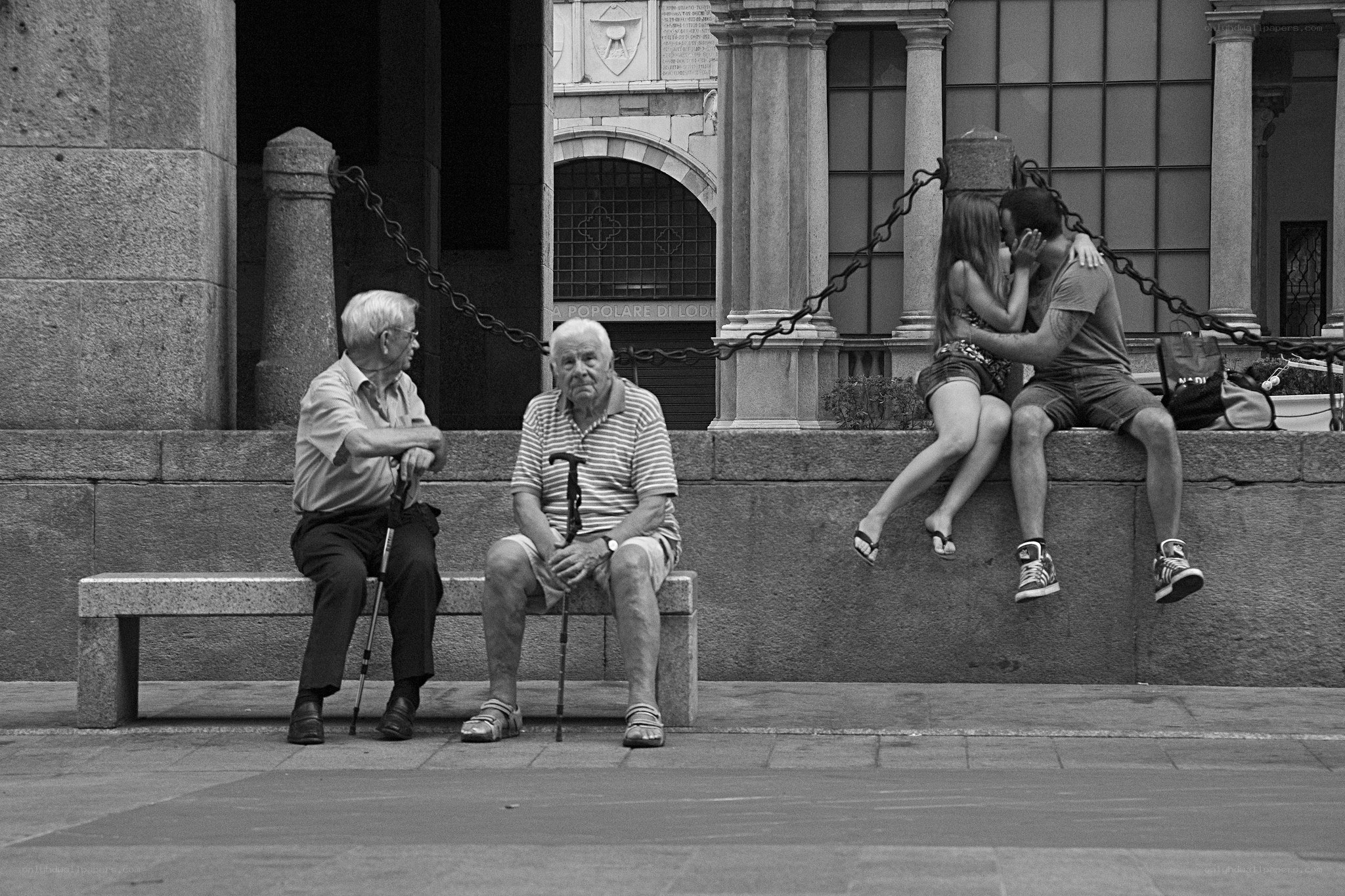 Elderly men and couple on bench