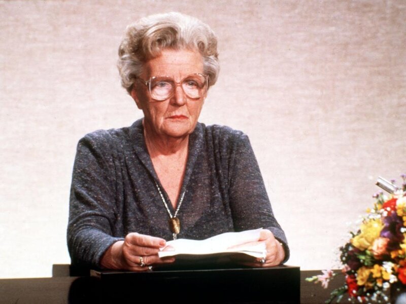 Elderly Woman at Podium