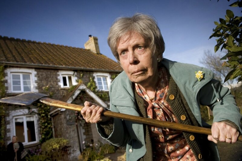 Elderly Woman Holding Axe