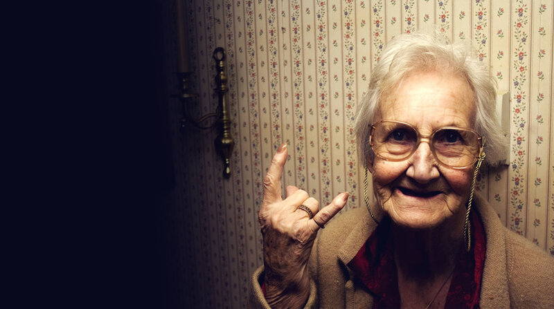 elderly woman making hand gesture