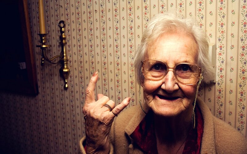 elderly woman making hand gesture