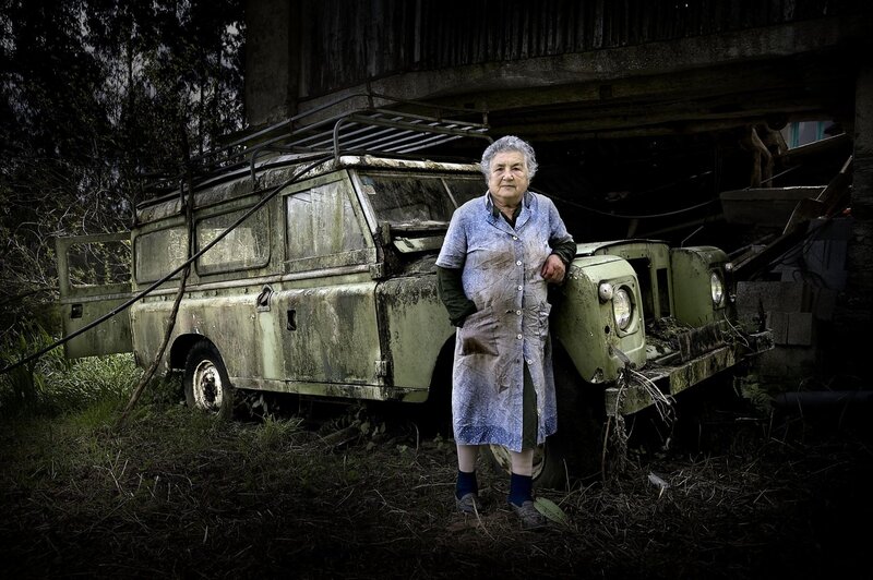 Elderly woman with old vehicle