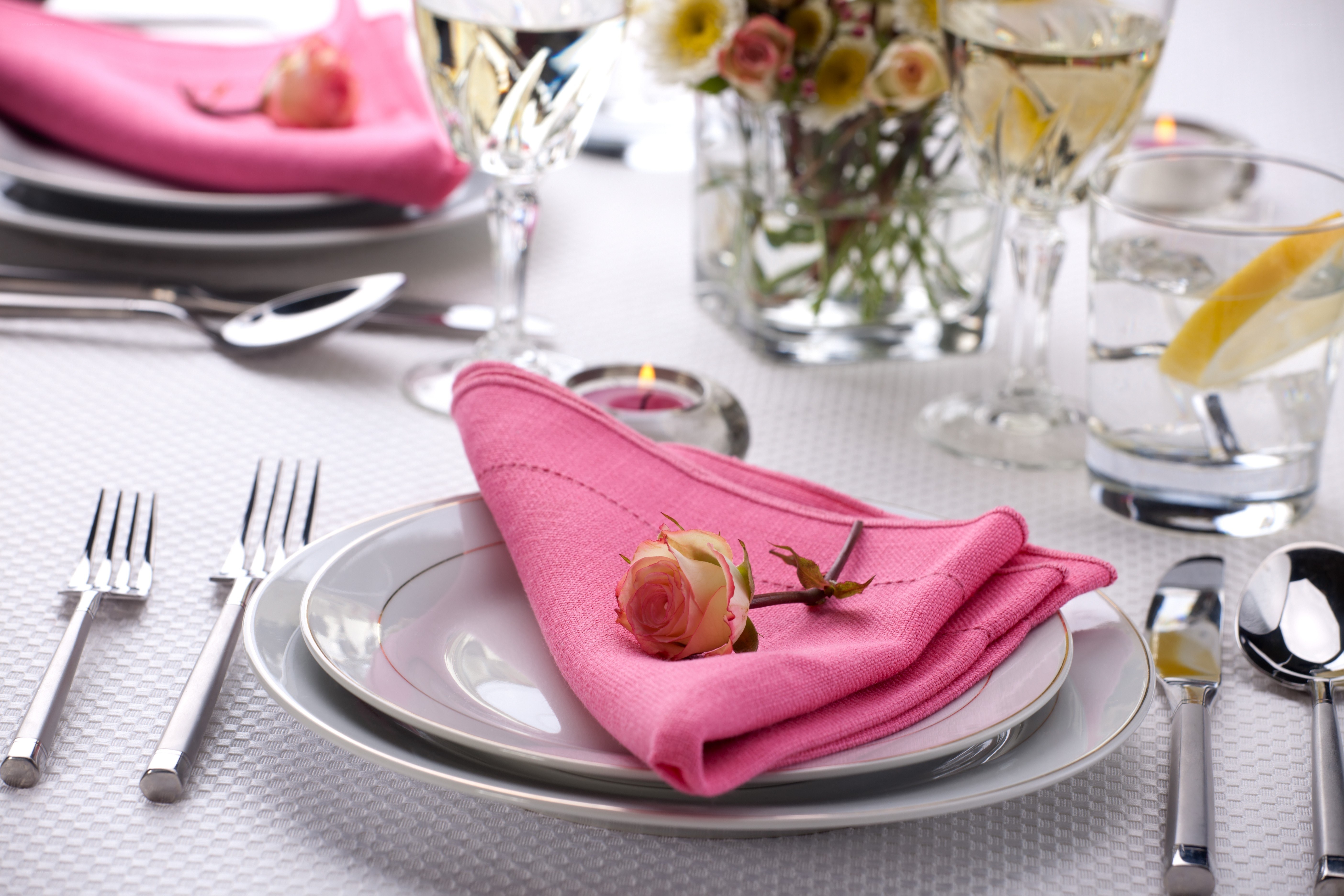Elegant table setting with pink napkin