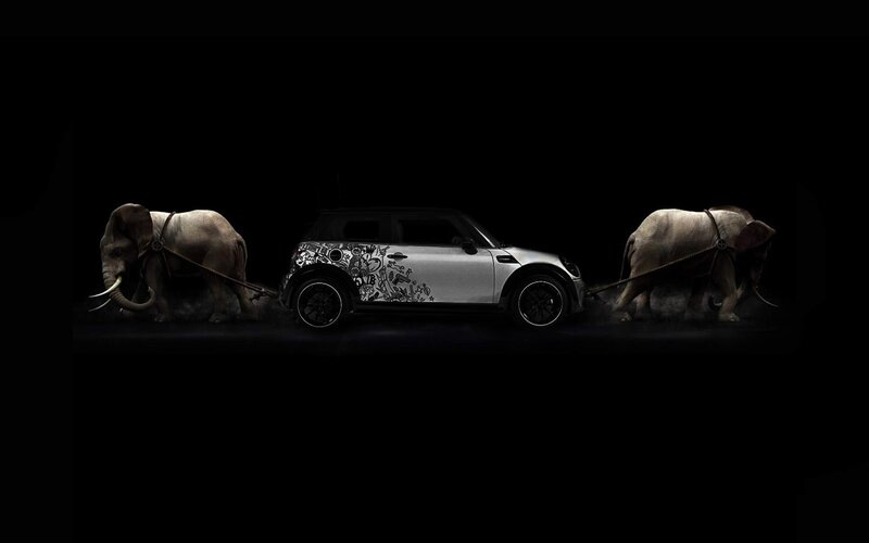 Elephants pulling a car