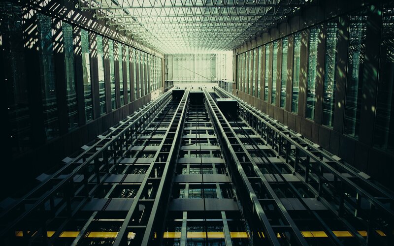 Elevator Shaft Interior — Black, Dramatic, Photograph, Metal Tracks