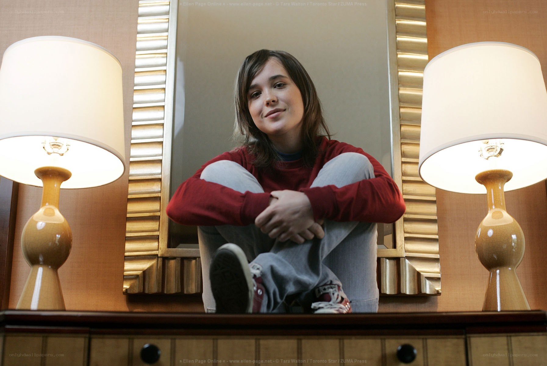 Ellen Page sitting on a table