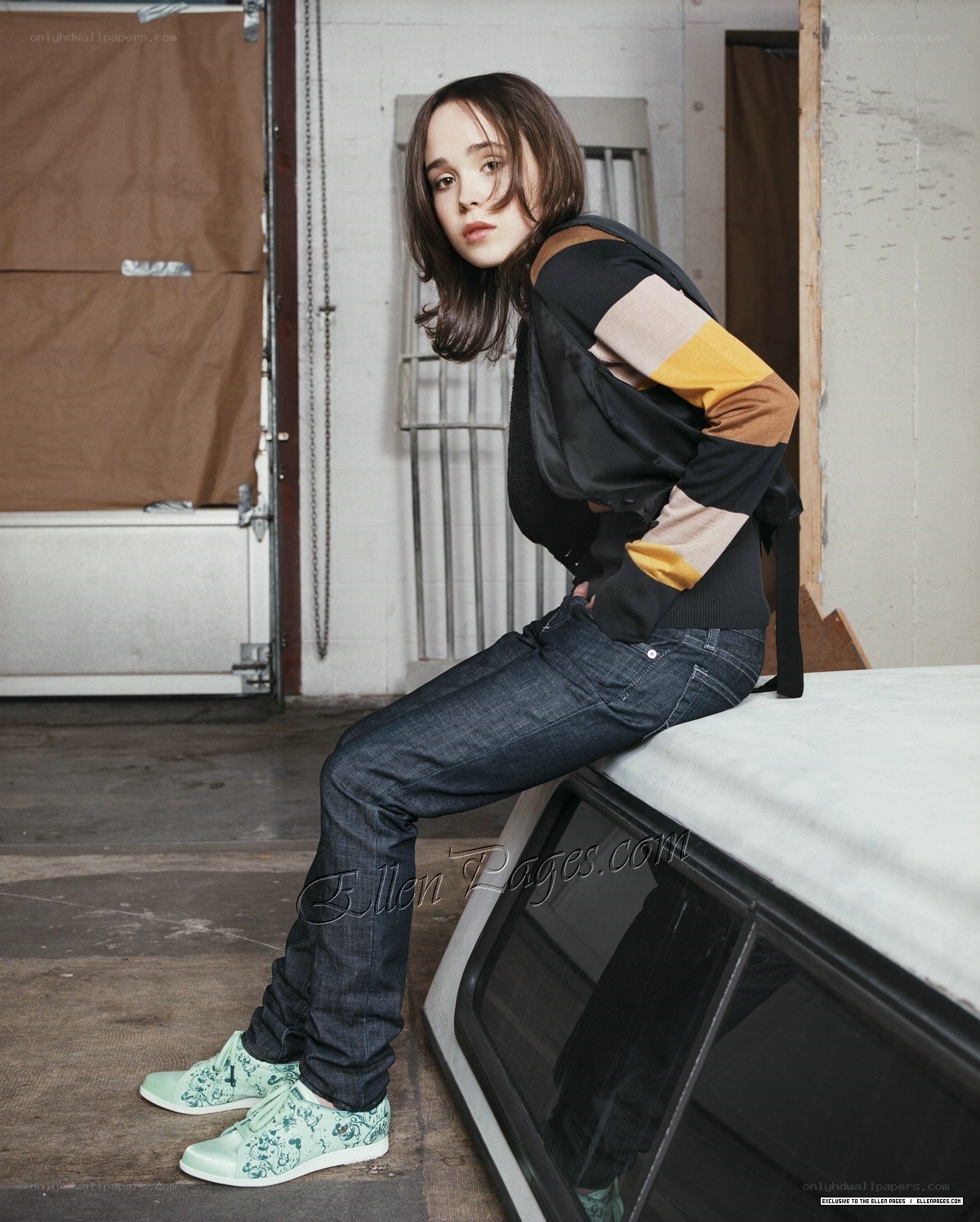Ellen Page sitting on car