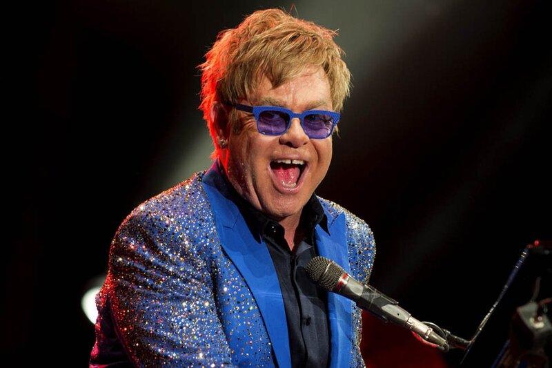 Elton John singing on stage