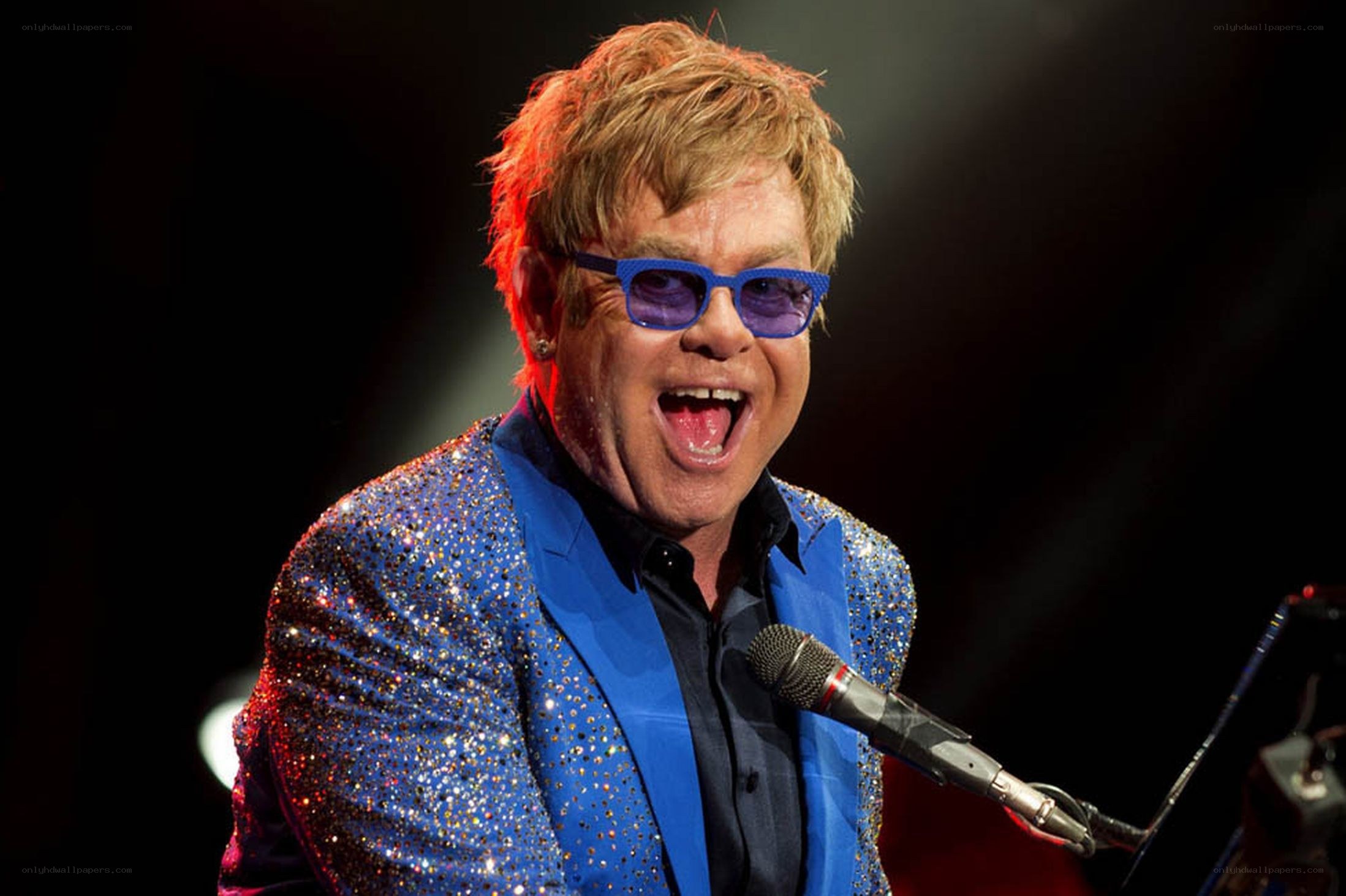 Elton John singing on stage