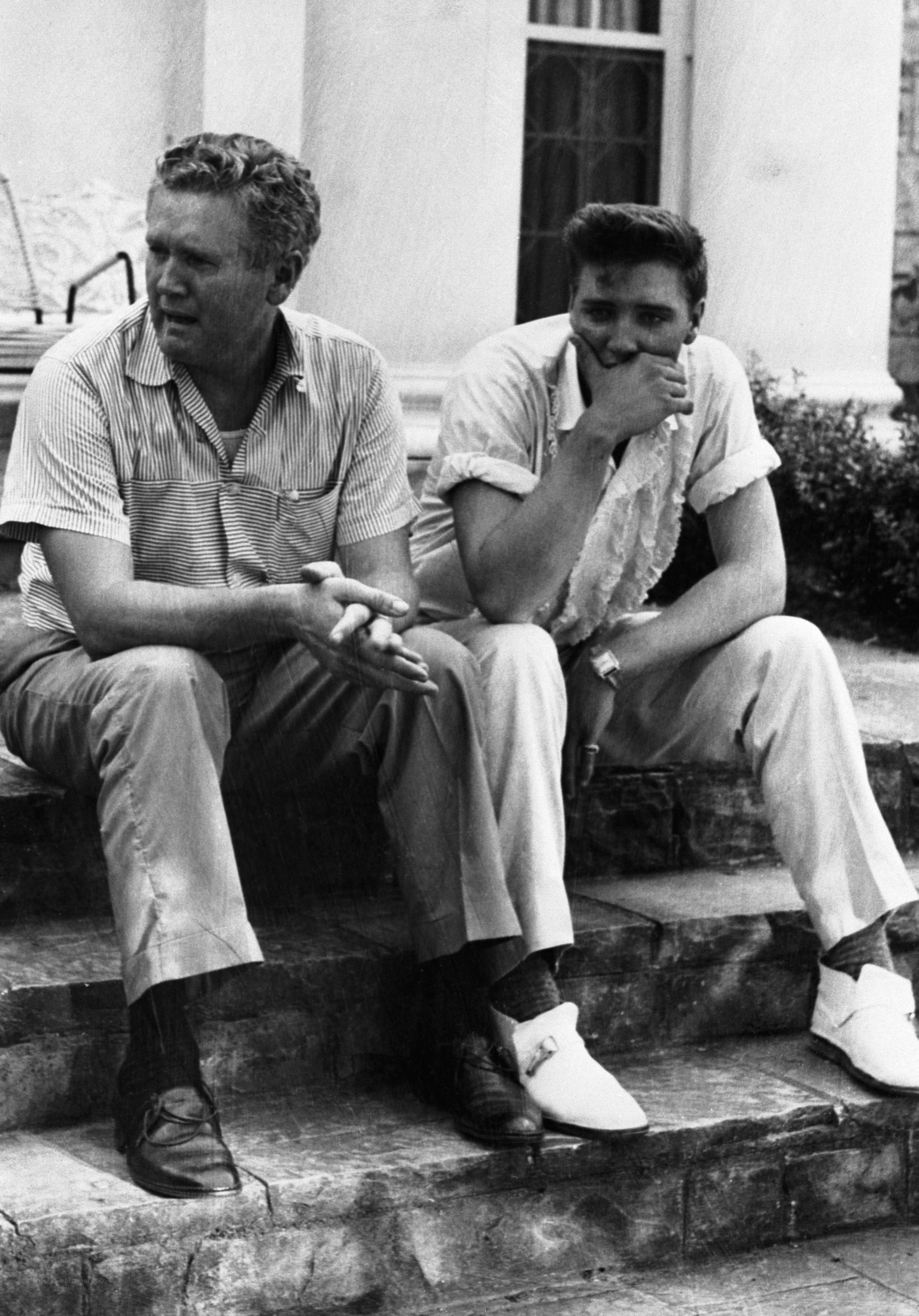 Elvis Presley with a man on steps