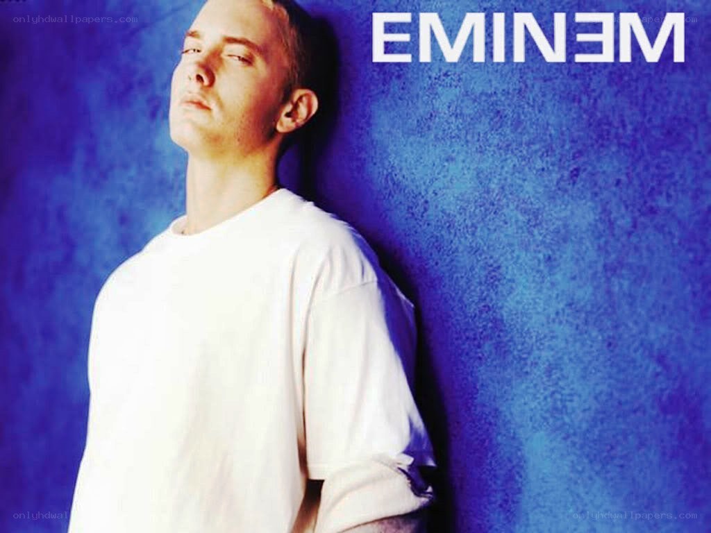 Eminem leaning against a blue wall