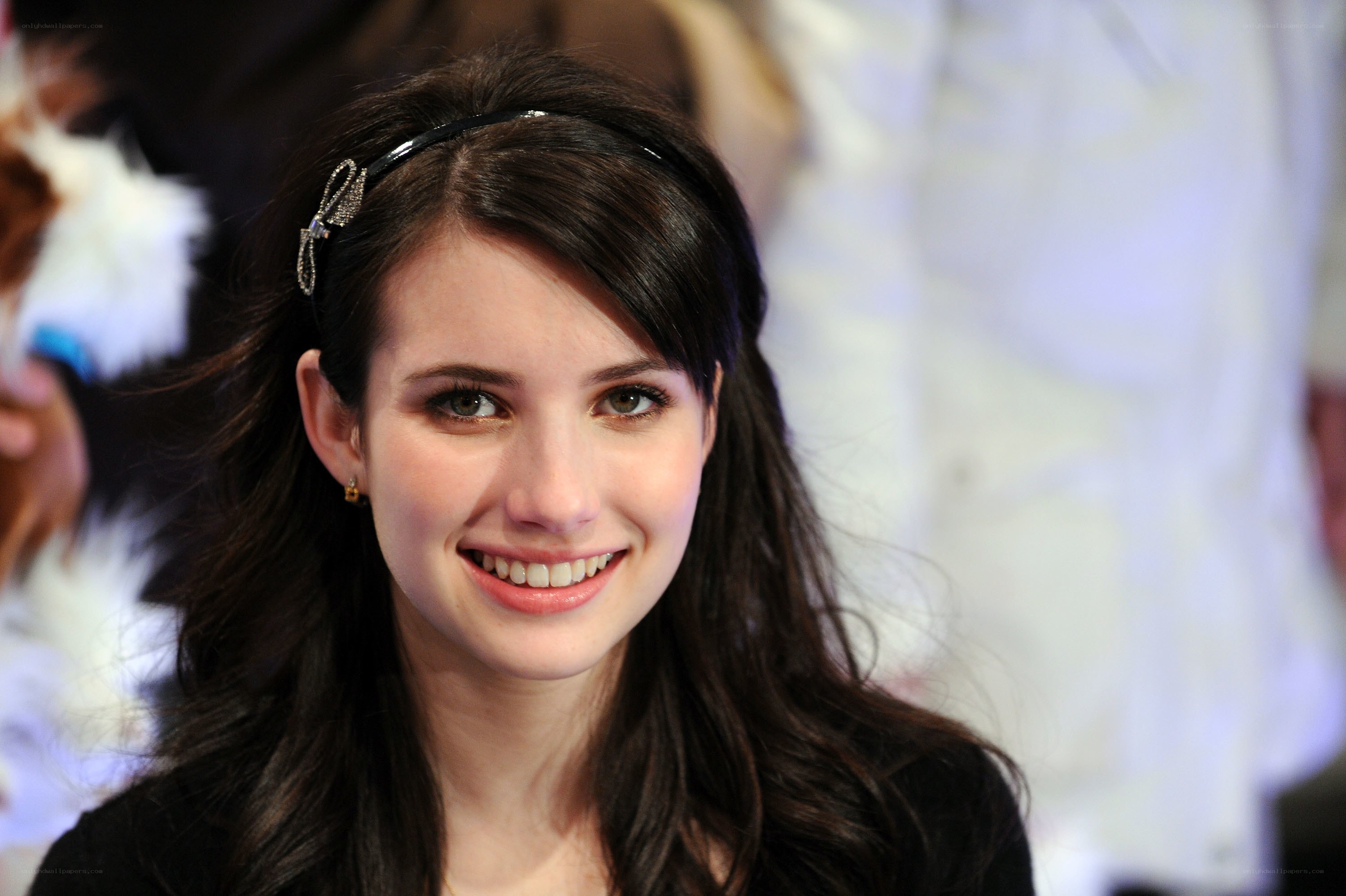 Emma Roberts smiling at event