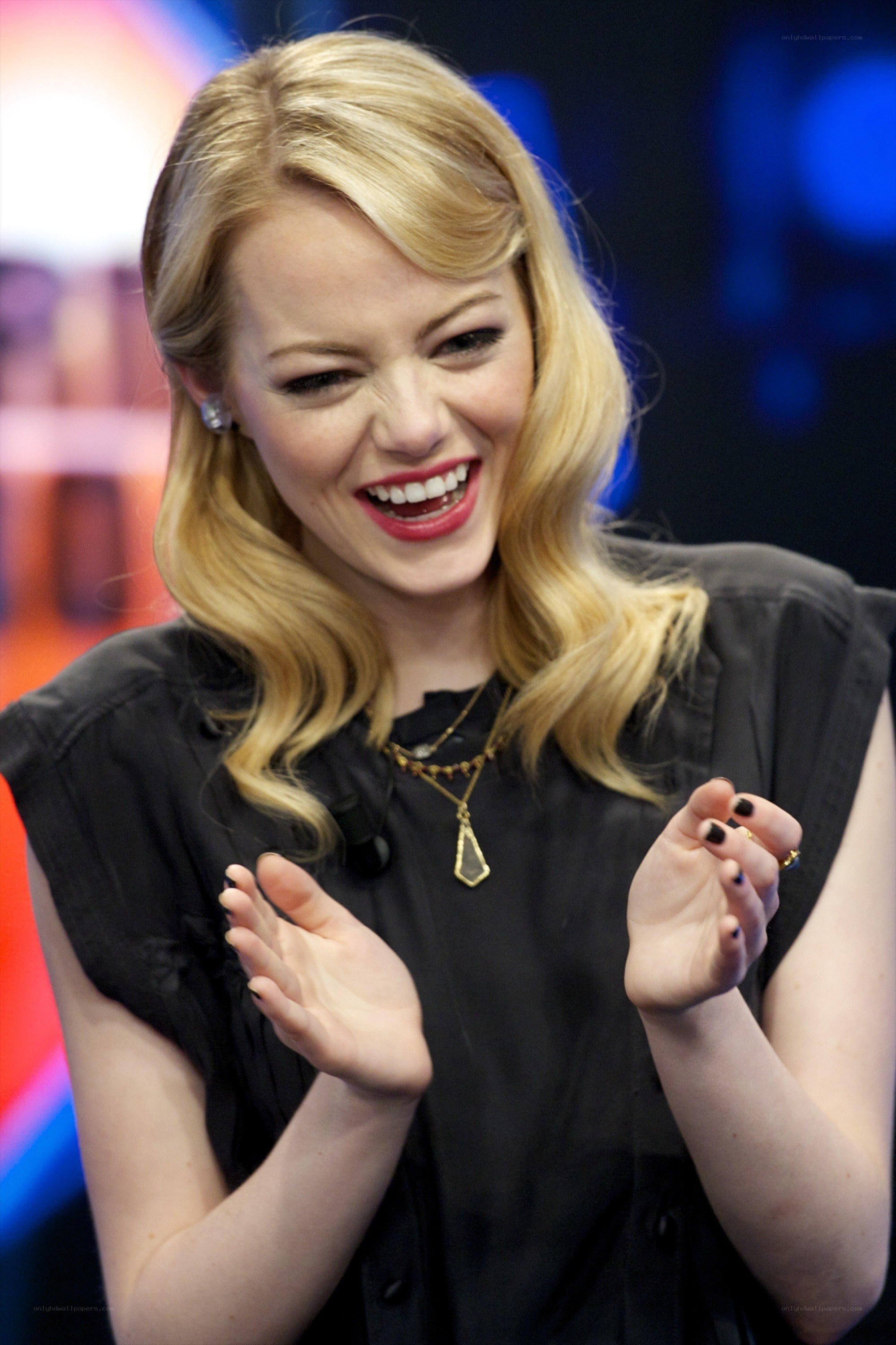 Emma Stone laughing on stage