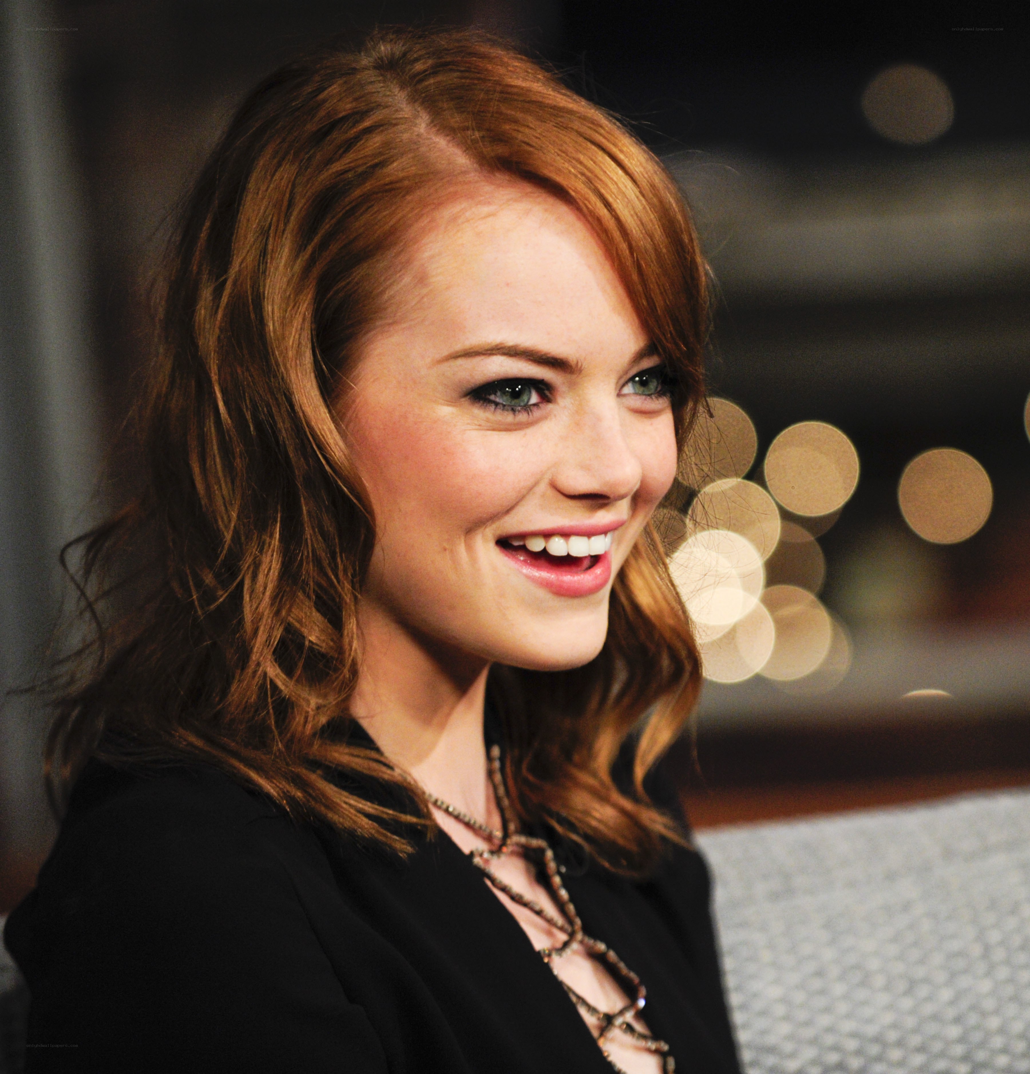 Emma Stone smiling on set