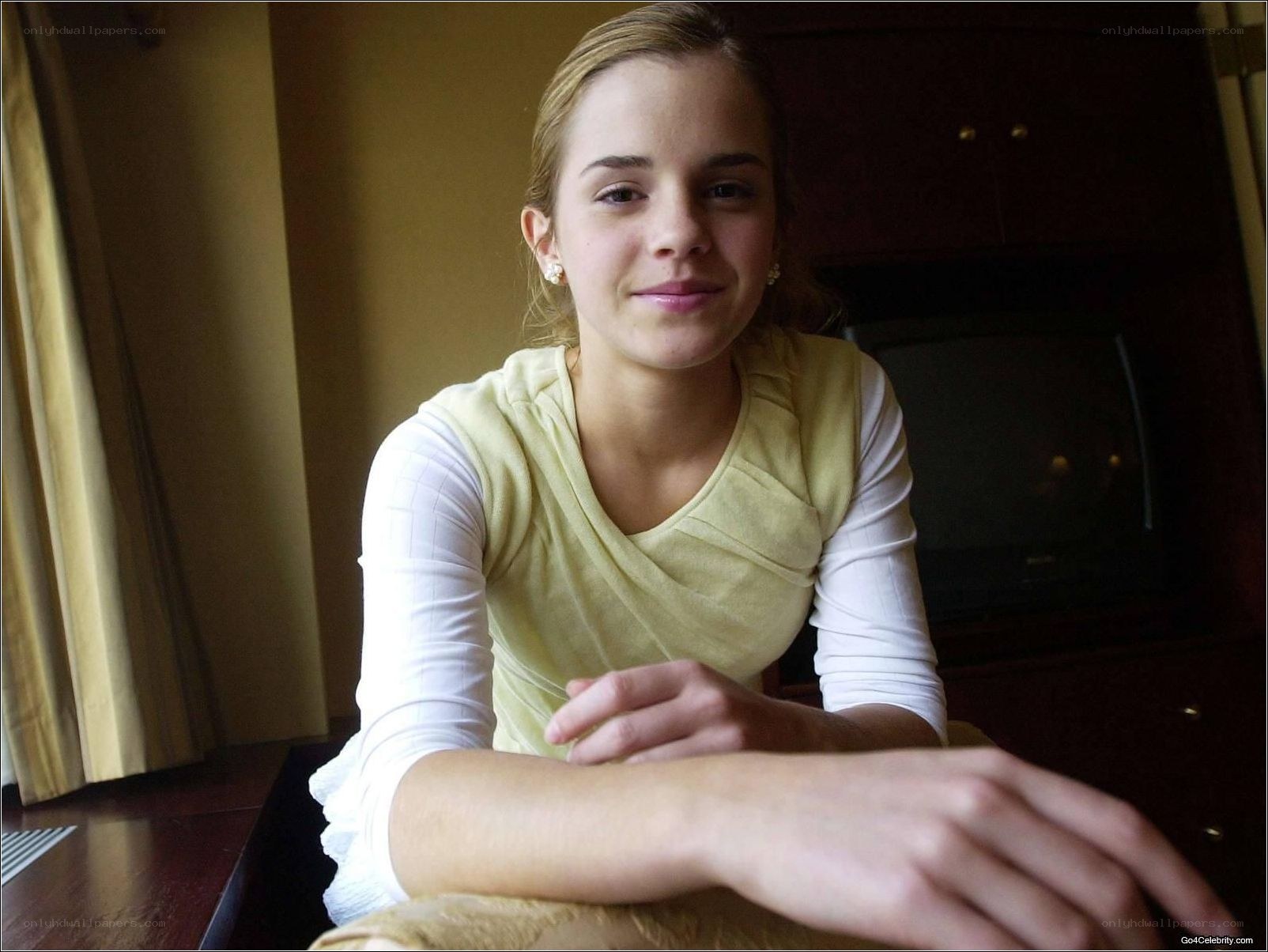 Emma Watson sitting at a table