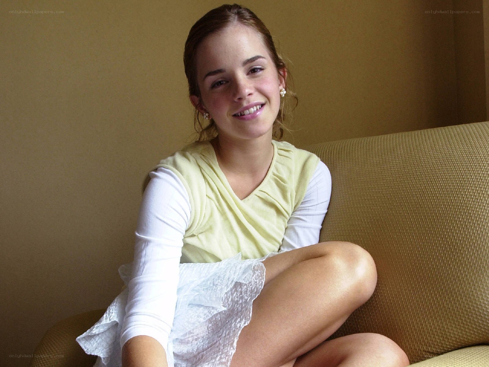 Emma Watson sitting on a couch