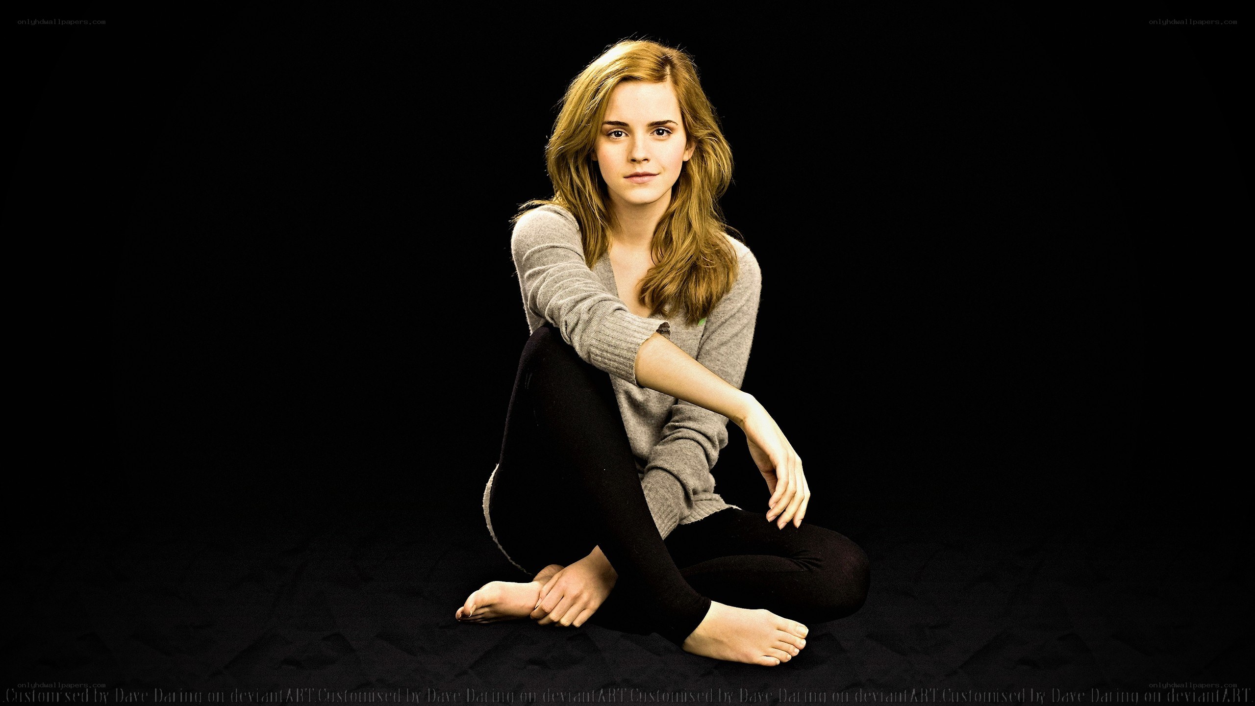 Emma Watson sitting on black background