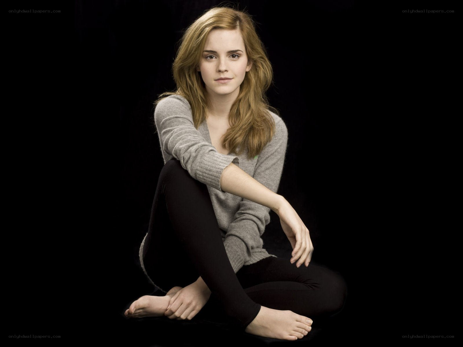 Emma Watson sitting on black