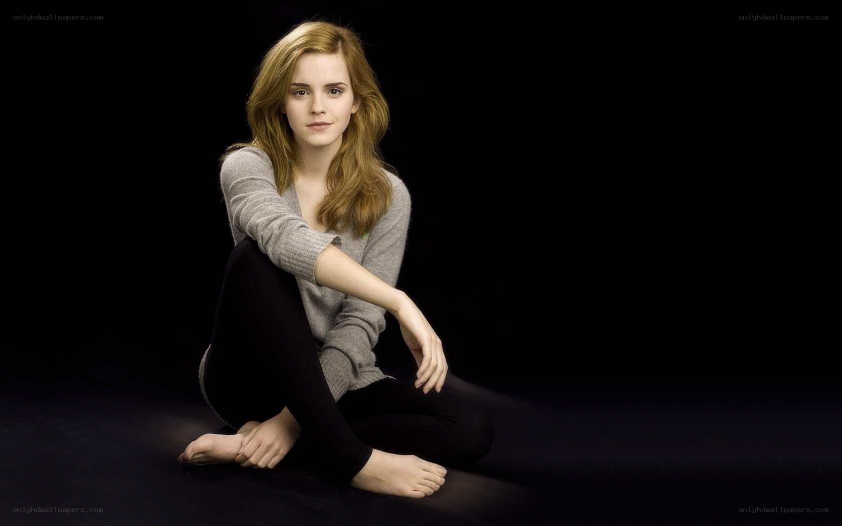 Emma Watson sitting on floor