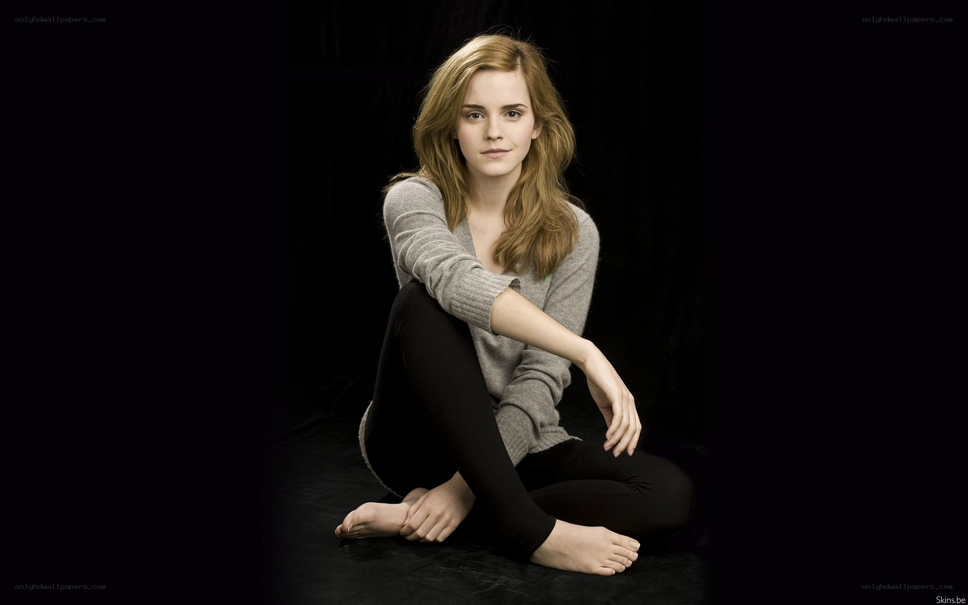 Emma Watson sitting on floor