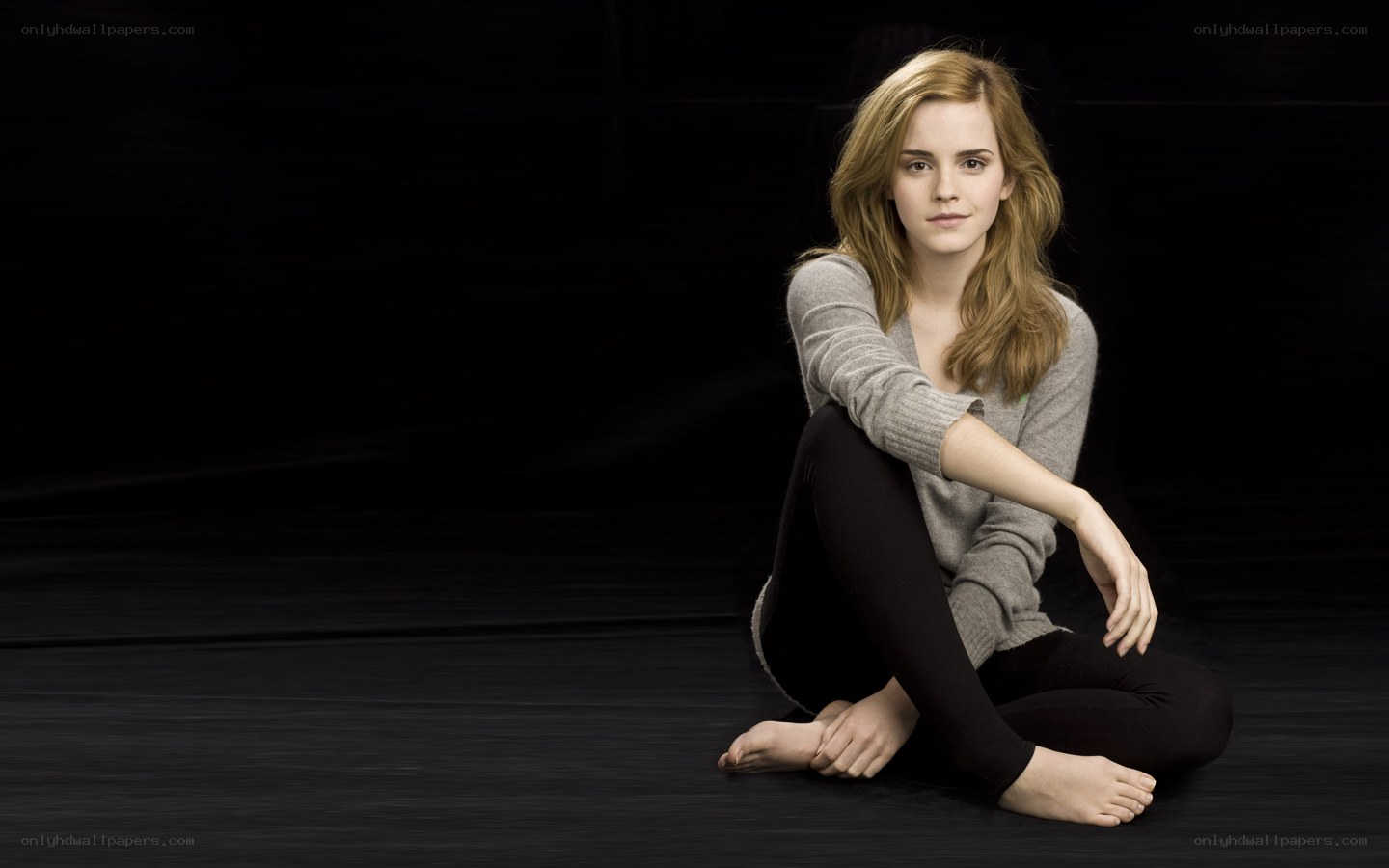 Emma Watson sitting on floor