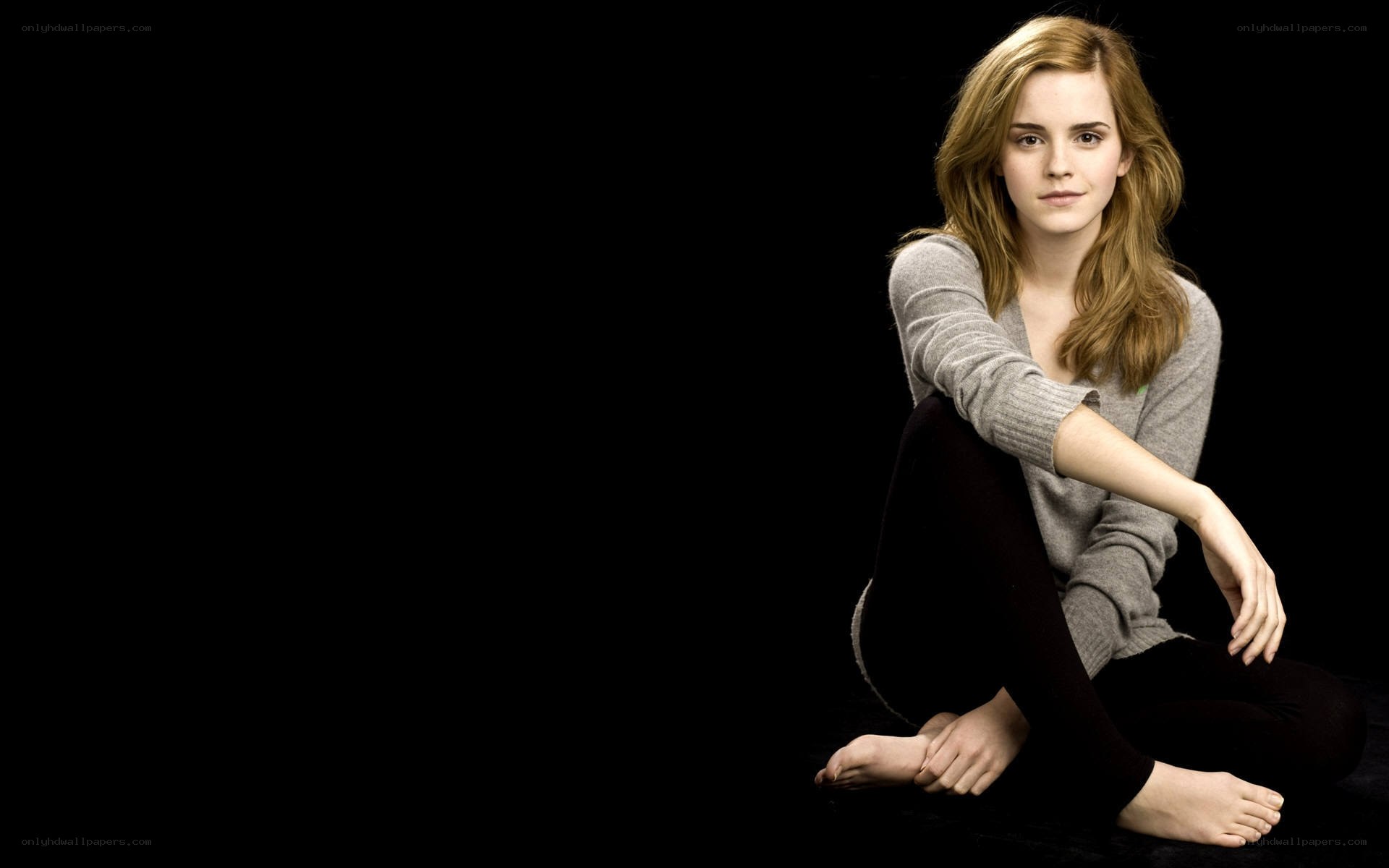 Emma Watson sitting on floor