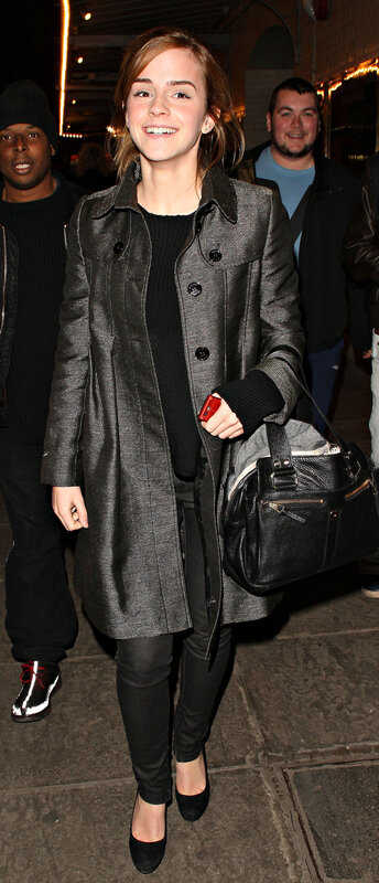 Emma Watson smiling in coat