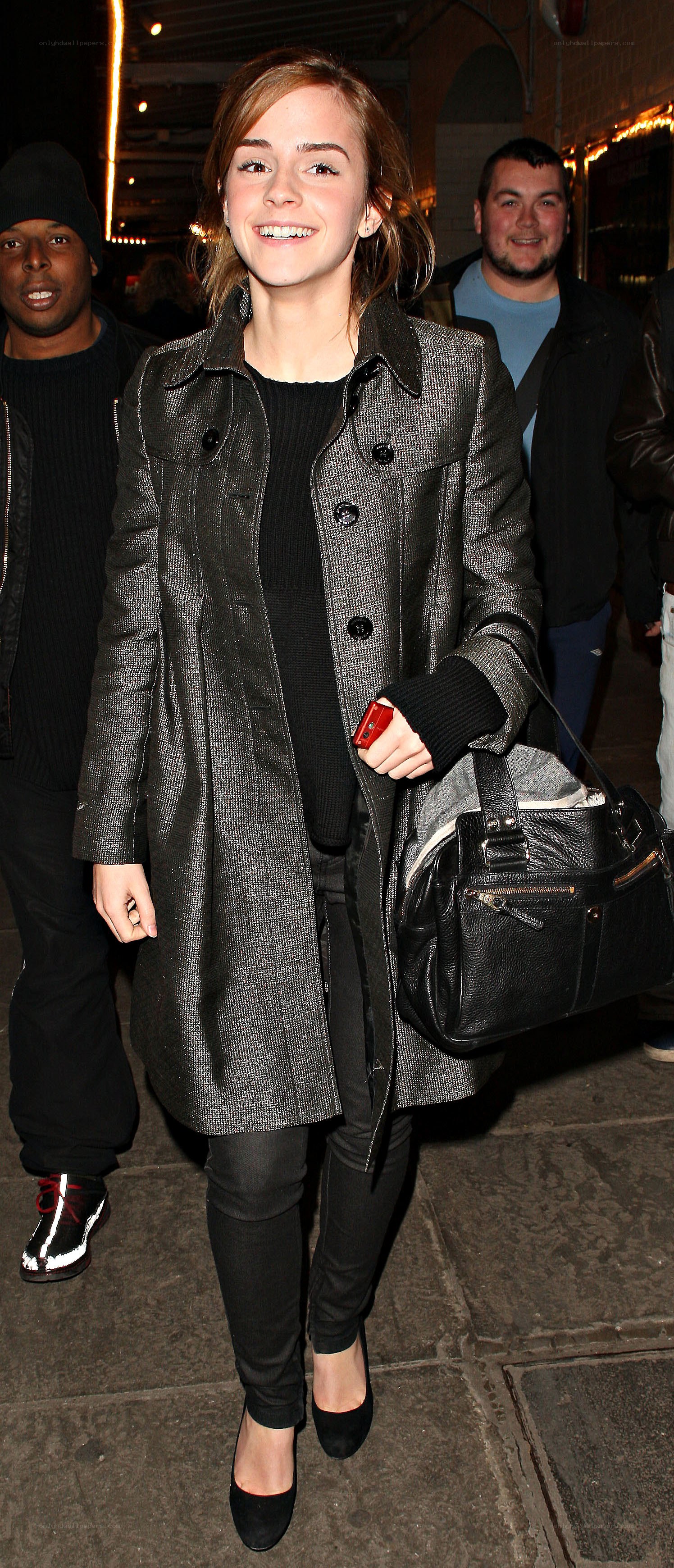 Emma Watson smiling in coat