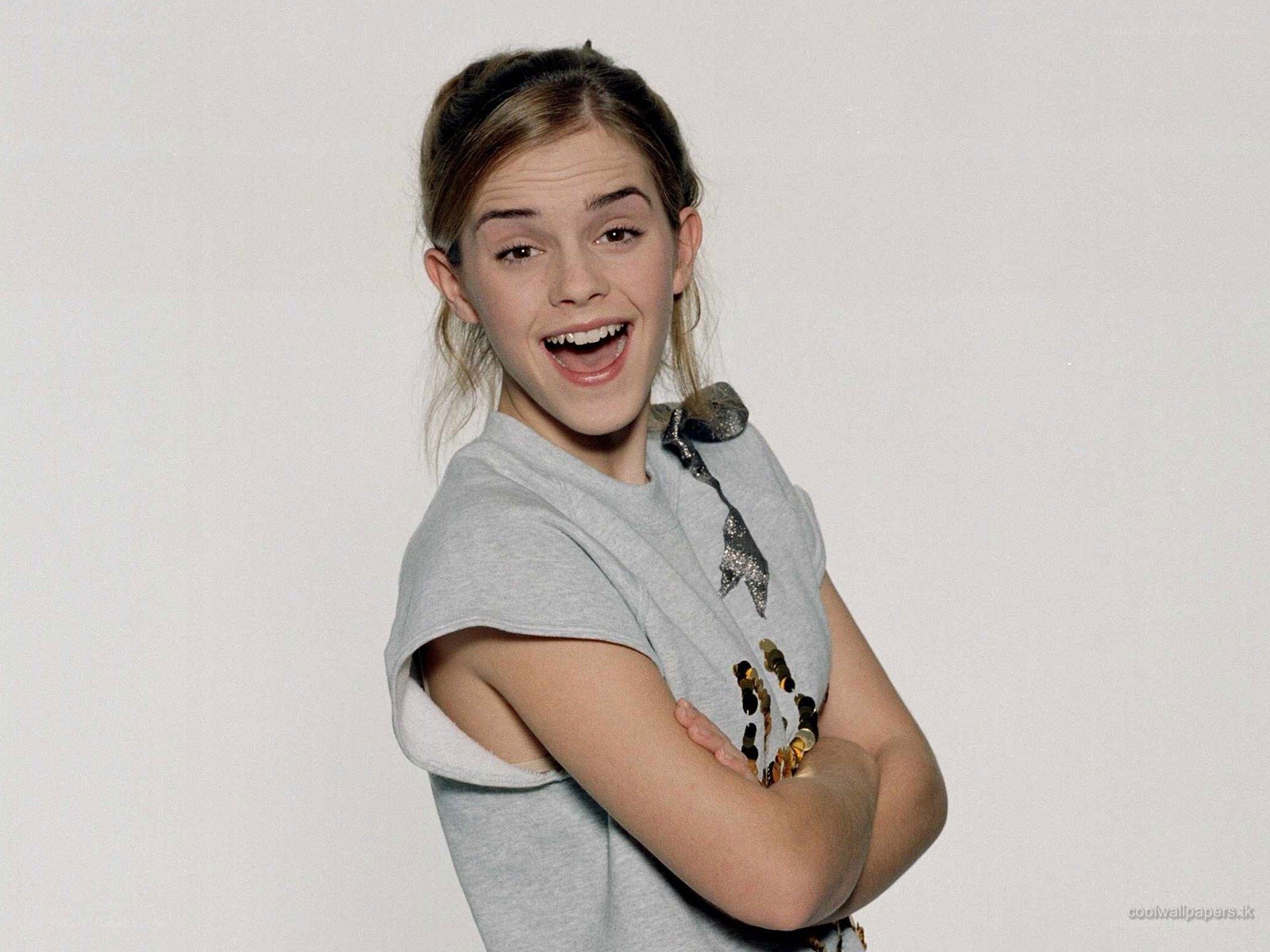 Emma Watson smiling with arms crossed