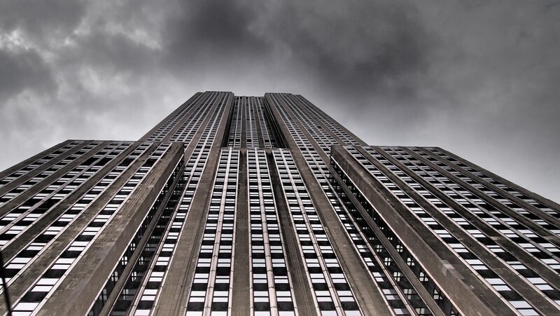 Empire State Building under stormy sky