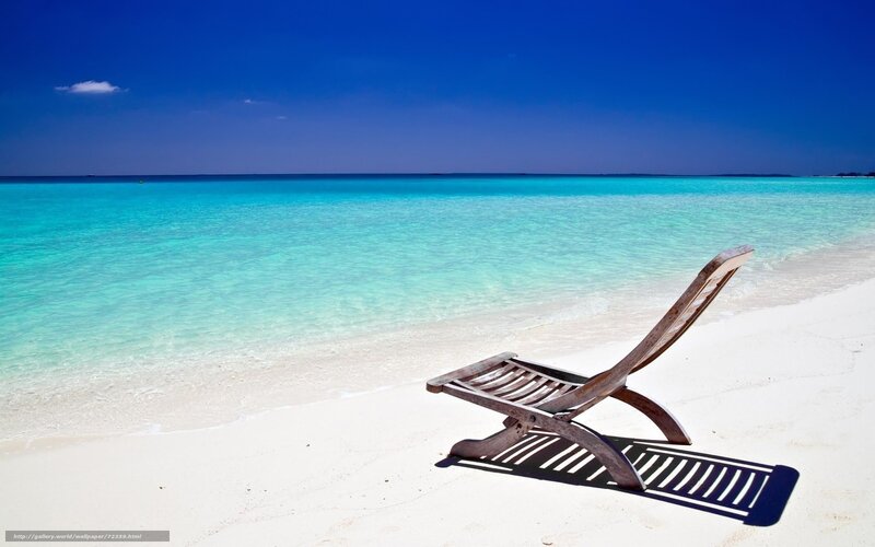 Empty beach chair on tropical shore