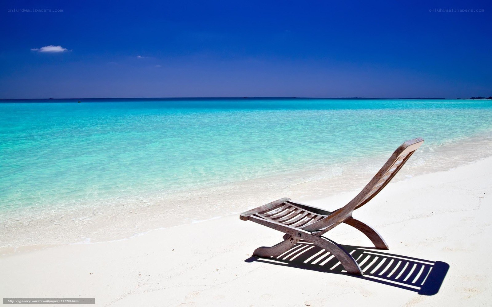 Empty beach chair on tropical shore