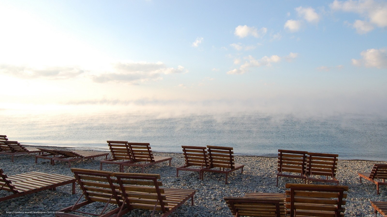 Empty beach chairs at sunrise