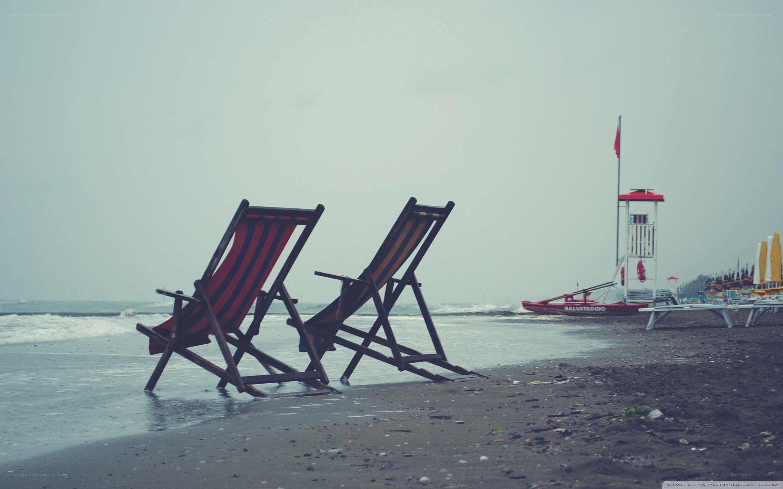 Empty beach chairs on a cloudy day
