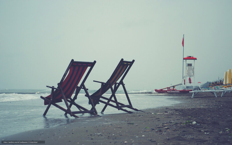 Empty beach chairs on a cloudy day