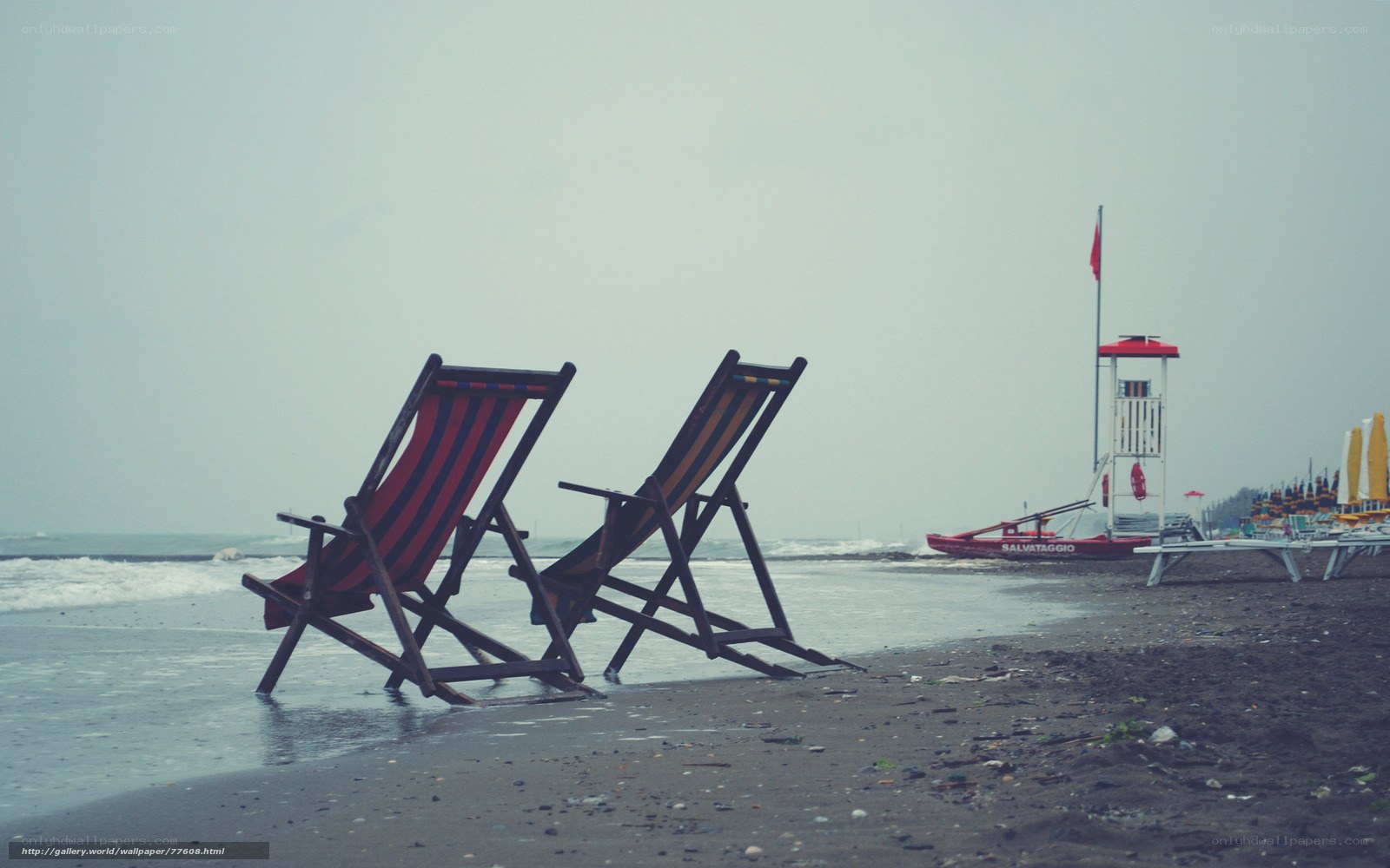 Empty beach chairs on a cloudy day