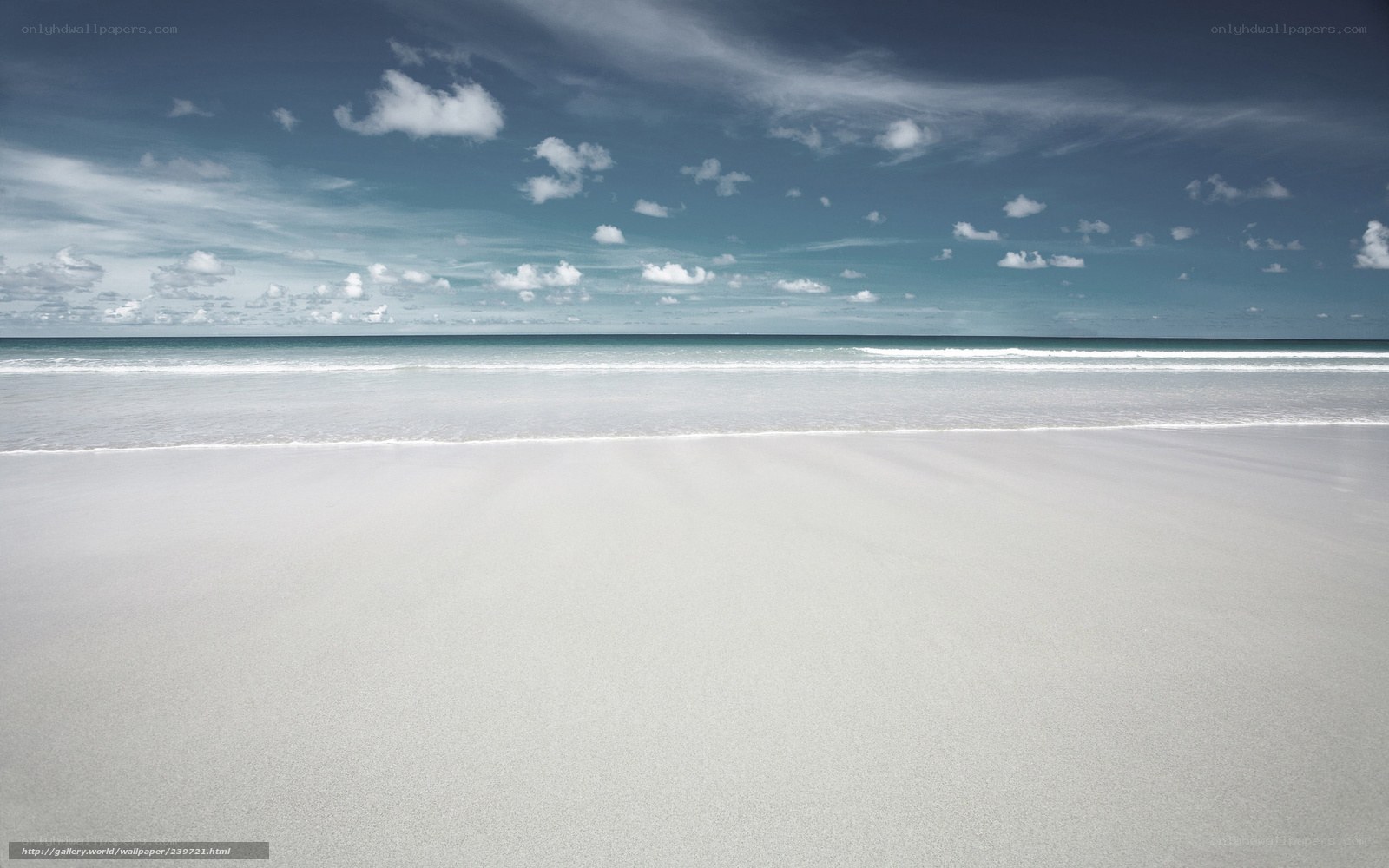 Empty beach under cloudy sky