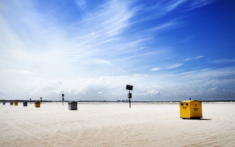 Empty beach with yellow kiosks