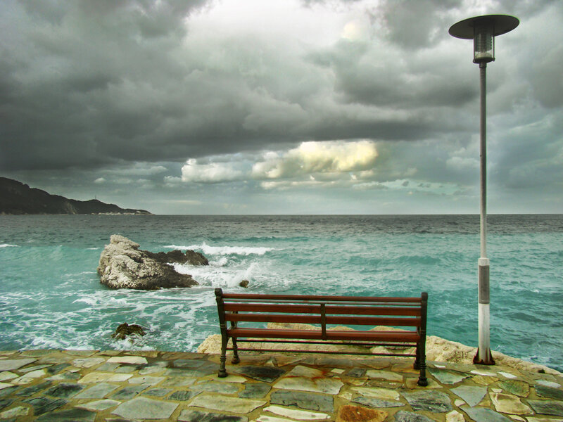 Empty bench by the sea