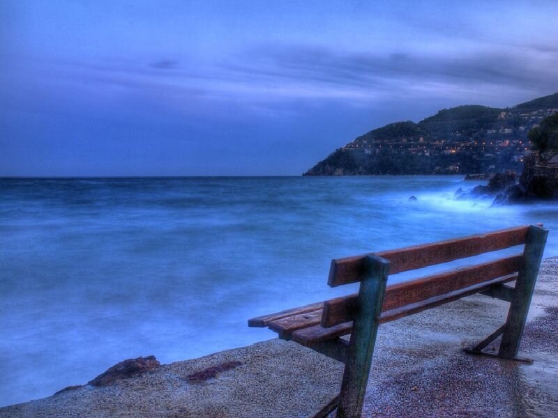Empty bench by the sea
