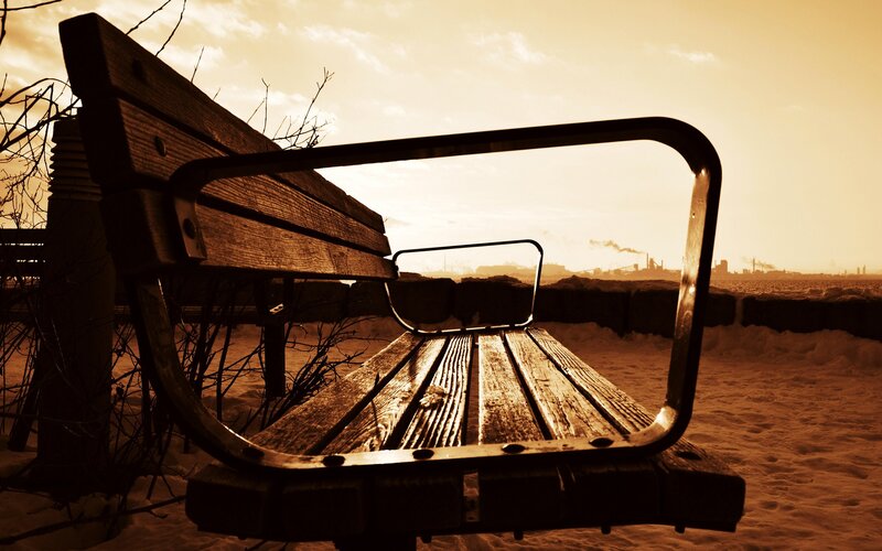 Empty bench in winter sunset