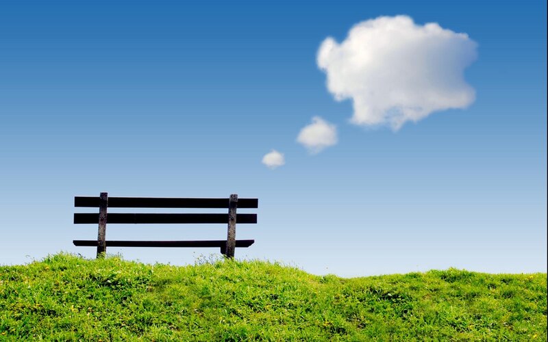Empty bench under blue sky