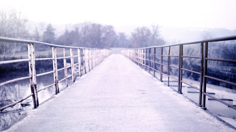 Empty bridge in misty landscape