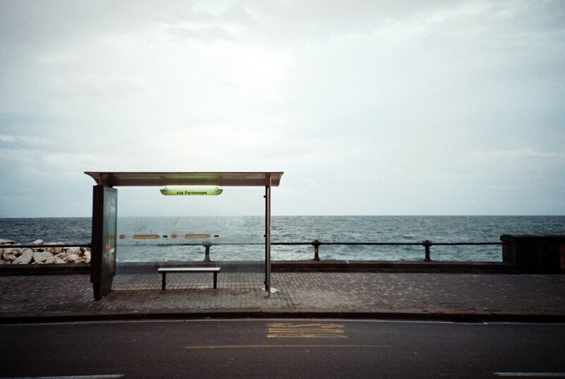 Empty bus stop by the sea