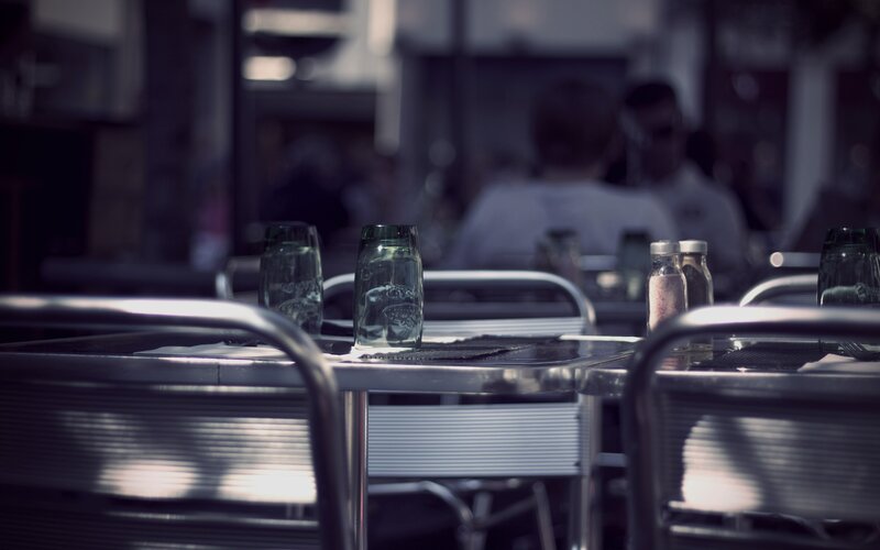 Empty cafe tables at dusk