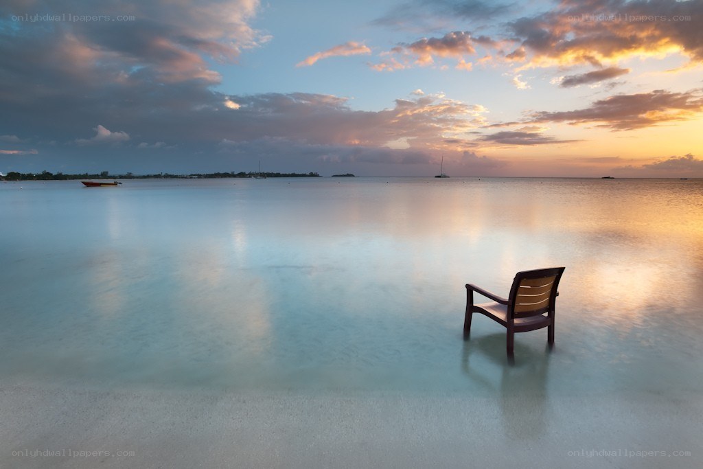 Empty chair at sunset on the beach