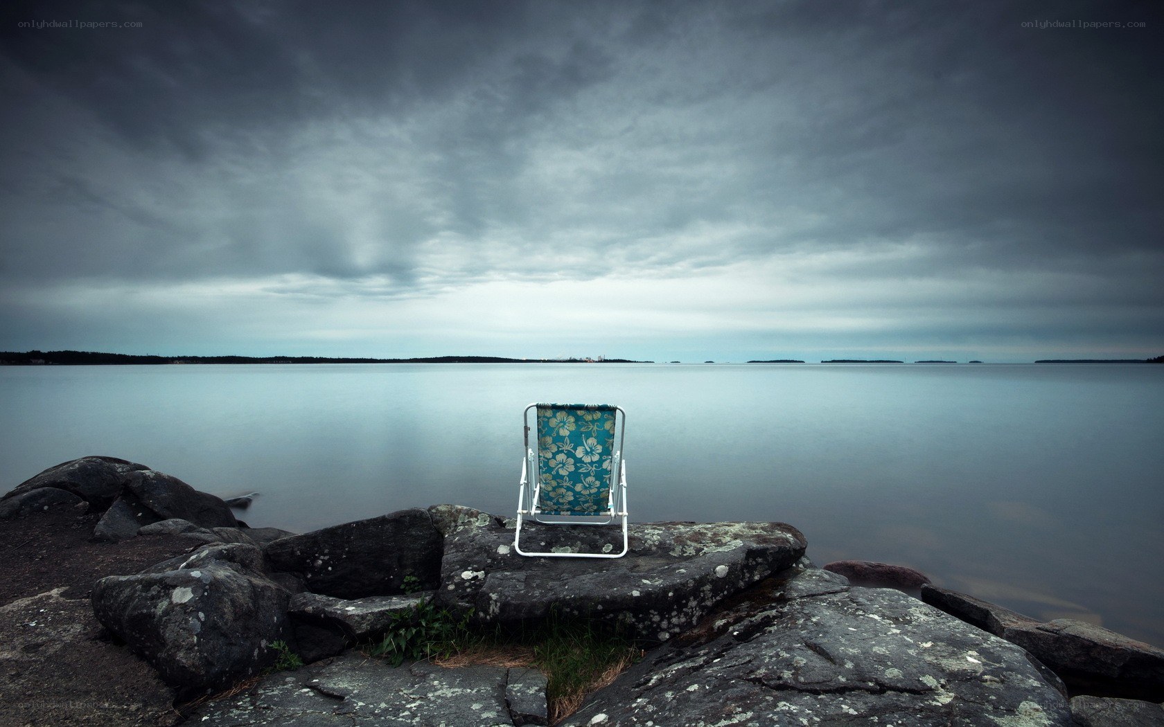 Empty chair by the water