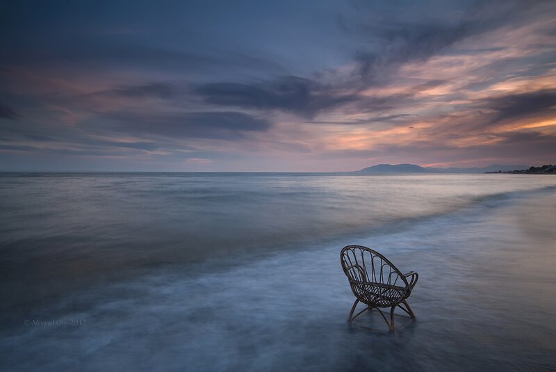 Empty chair on a beach at dusk